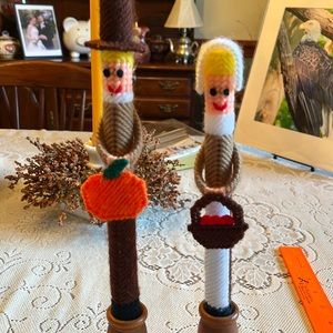 Thanksgiving decoration. 2 Pilgrims made out of yarn in wooden holders